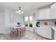 Bright kitchen and dining area with white cabinets and light blue walls at 3462 Briar Creek Ln, Carmel, IN 46033