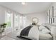 Sunlit main bedroom with neutral tones, bay windows, and soft carpet flooring at 3462 Briar Creek Ln, Carmel, IN 46033