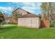 Backyard shed for extra storage space, nestled in a lush green lawn at 3462 Briar Creek Ln, Carmel, IN 46033