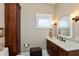 Charming bathroom with white countertops, wood cabinets, and classic fixtures at 350 W Pearl St, Greenwood, IN 46142