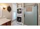 Bathroom features a stackable washer and dryer, hexagon tiles, and glass enclosed shower at 350 W Pearl St, Greenwood, IN 46142