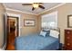 Cozy bedroom with a ceiling fan, natural light from the window, and hardwood floors at 350 W Pearl St, Greenwood, IN 46142