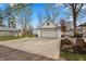 Spacious driveway leading to the detached two-car garage with white siding and a gabled roof at 350 W Pearl St, Greenwood, IN 46142