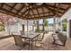 Outdoor dining area with a covered gazebo, brick patio, and a charming swing at 350 W Pearl St, Greenwood, IN 46142