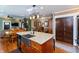 Open-concept kitchen with granite countertops, stainless steel appliances, and custom cabinetry at 350 W Pearl St, Greenwood, IN 46142