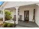 Relaxing front porch with rocking chairs, ceiling fan and a welcoming entrance with glass-paneled door at 350 W Pearl St, Greenwood, IN 46142