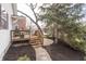 Inviting back deck with wood flooring, exterior steps, seating, and landscaped backyard with stone walkway at 356 S Washington St, Danville, IN 46122