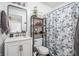 This stylish bathroom features modern fixtures, decorative mirror, and patterned shower curtain at 356 S Washington St, Danville, IN 46122