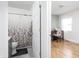Bright bathroom featuring a shower with curtain and a peek into an adjacent bedroom space at 356 S Washington St, Danville, IN 46122