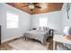 Cozy bedroom with wood-paneled ceiling features a ceiling fan, and ample natural light from multiple windows at 356 S Washington St, Danville, IN 46122