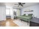 Light-filled bedroom with en-suite bathroom features a ceiling fan and sliding barn door at 356 S Washington St, Danville, IN 46122