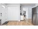The entryway features a convenient closet, entry door with smart lock, and wood-look flooring at 356 S Washington St, Danville, IN 46122