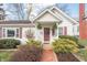 Charming home with red shutters, inviting front porch, and a lovely landscaped front yard at 356 S Washington St, Danville, IN 46122
