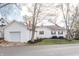 Rear view featuring the garage, connected to the house, with meticulously maintained landscaping at 356 S Washington St, Danville, IN 46122