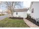 Detached garage with an adjacent lawn and a stone pathway leading to the main house at 356 S Washington St, Danville, IN 46122