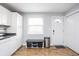 Bright kitchen boasts white cabinets, modern flooring, and entry door with smart lock at 356 S Washington St, Danville, IN 46122