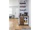 Stylish coffee bar area with floating shelves and a barn door cabinet detail adds charm to this kitchen at 356 S Washington St, Danville, IN 46122