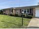 Well-kept brick home with trimmed hedges, lush green lawn, and inviting front porch at 359 Anel Dr, Martinsville, IN 46151