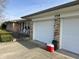 Attached two-car garage features a red cooler and white doors, complementing the home's exterior at 359 Anel Dr, Martinsville, IN 46151