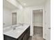 Bathroom featuring double sinks, a large mirror, and an open doorway to closet at 3727 Thomas Jefferson Ct, Westfield, IN 46074