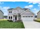 Charming two-story home featuring a two-car garage, stone accents, and a well-manicured lawn at 3727 Thomas Jefferson Ct, Westfield, IN 46074