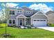 Charming two-story home featuring a manicured lawn, two-car garage, and stylish gray siding at 3727 Thomas Jefferson Ct, Westfield, IN 46074