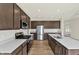 A well-lit kitchen with stainless steel appliances, a kitchen island, and white subway tile at 3727 Thomas Jefferson Ct, Westfield, IN 46074