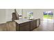 The kitchen island features a sink, dishwasher, and a white quartz countertop at 3727 Thomas Jefferson Ct, Westfield, IN 46074