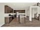 Open-concept kitchen features stainless steel appliances, a kitchen island, and a wood floor at 3727 Thomas Jefferson Ct, Westfield, IN 46074