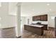 This kitchen features stainless steel appliances, a kitchen island, and sliding doors to the patio at 3727 Thomas Jefferson Ct, Westfield, IN 46074