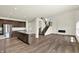 Open-concept living space with a staircase, fireplace, and kitchen island at 3727 Thomas Jefferson Ct, Westfield, IN 46074