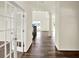 Bright foyer featuring hardwood floors, glass panel doors, and an open staircase at 3727 Thomas Jefferson Ct, Westfield, IN 46074