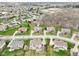 Aerial view of the home surrounded by mature trees, other homes, and a lake at 3932 Long Ridge Blvd, Carmel, IN 46074