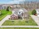 Expansive aerial view of a brick home with lush landscaping, long drive, and mature trees in a serene neighborhood at 3932 Long Ridge Blvd, Carmel, IN 46074