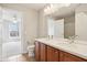 Well-lit bathroom featuring a dual sink vanity with a large mirror and an adjoining bedroom view at 3932 Long Ridge Blvd, Carmel, IN 46074