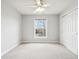 Neutral bedroom with a ceiling fan and a large window providing ample natural light and a closet at 3932 Long Ridge Blvd, Carmel, IN 46074