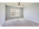 Neutral bedroom with a ceiling fan and a large window providing ample natural light and exterior views at 3932 Long Ridge Blvd, Carmel, IN 46074