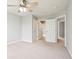 Neutral bedroom with a ceiling fan, carpet flooring, closet, and natural light from multiple doorways at 3932 Long Ridge Blvd, Carmel, IN 46074