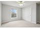 Neutral bedroom with a ceiling fan and a large window providing ample natural light and a closet at 3932 Long Ridge Blvd, Carmel, IN 46074