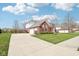 Spacious home with long driveway, attached garage, complemented by lush green lawn and mature trees at 3932 Long Ridge Blvd, Carmel, IN 46074