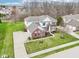 Charming two-story brick home with a well-manicured lawn and attached three-car garage at 3932 Long Ridge Blvd, Carmel, IN 46074