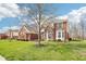 Attractive brick home with manicured lawn and mature trees, showcasing a welcoming entrance and classic curb appeal at 3932 Long Ridge Blvd, Carmel, IN 46074