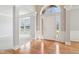 Bright foyer with hardwood floors, white trim, and natural light, offering a glimpse into an open-concept living space at 3932 Long Ridge Blvd, Carmel, IN 46074