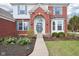 Inviting brick home featuring a beautifully landscaped walkway leading to a charming arched doorway and well-kept lawn at 3932 Long Ridge Blvd, Carmel, IN 46074