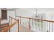 Bright hallway featuring hardwood railings, white balusters, neutral carpet, and ample natural light from large windows at 3932 Long Ridge Blvd, Carmel, IN 46074