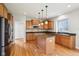 Bright kitchen featuring wooden cabinets, granite countertops, and hardwood flooring at 3932 Long Ridge Blvd, Carmel, IN 46074