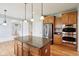 Open-concept kitchen with stainless steel appliances and central island for food prep at 3932 Long Ridge Blvd, Carmel, IN 46074
