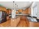 Well-lit kitchen with wooden cabinets, stainless steel appliances, and island with seating at 3932 Long Ridge Blvd, Carmel, IN 46074