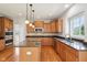 Open kitchen with granite countertops, stainless steel appliances, and center island at 3932 Long Ridge Blvd, Carmel, IN 46074