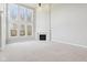 Bright and airy living room with a fireplace and lots of natural light from large windows at 3932 Long Ridge Blvd, Carmel, IN 46074